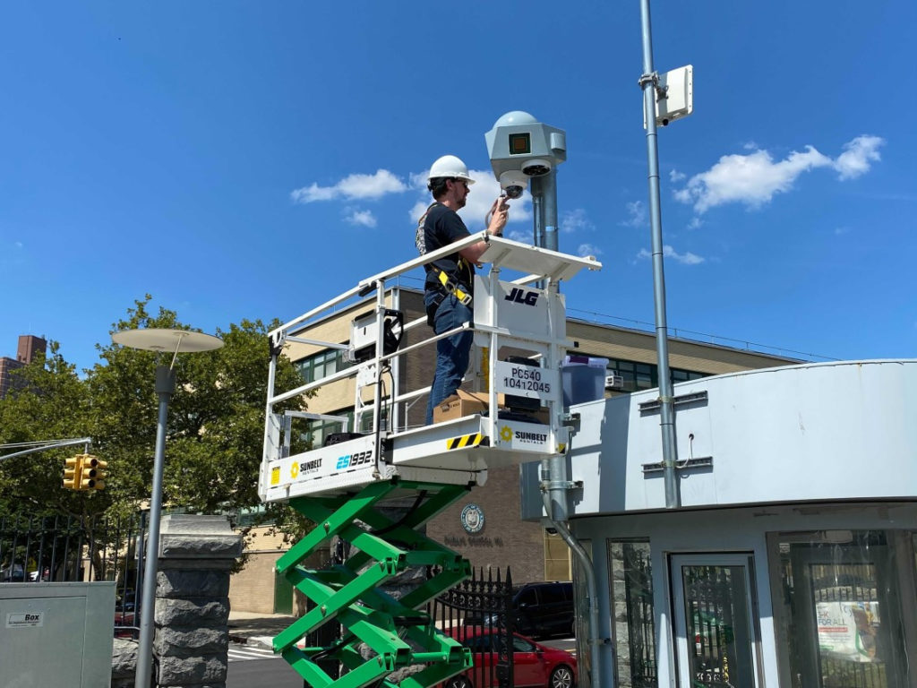 Jakub Kolodziejski (Rutgers/WINLAB) installed one of the COSMOS medium nodes, composed of mmWave radios, sub-6GHz radios and cameras. (Columbia Engineering)